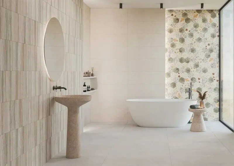 Light bathroom interior with ceramic surfaces and a freestanding bathtub
