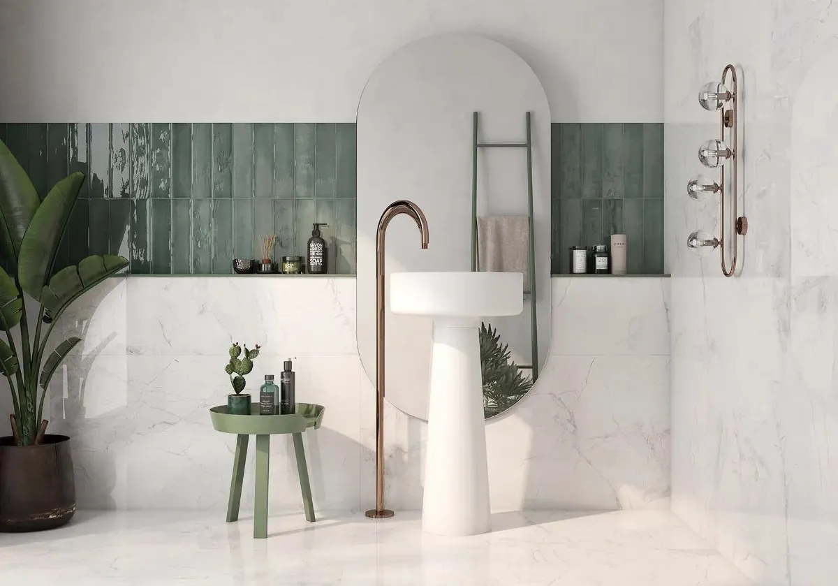 Green ceramic bathroom wall tiles behind a basin and bath